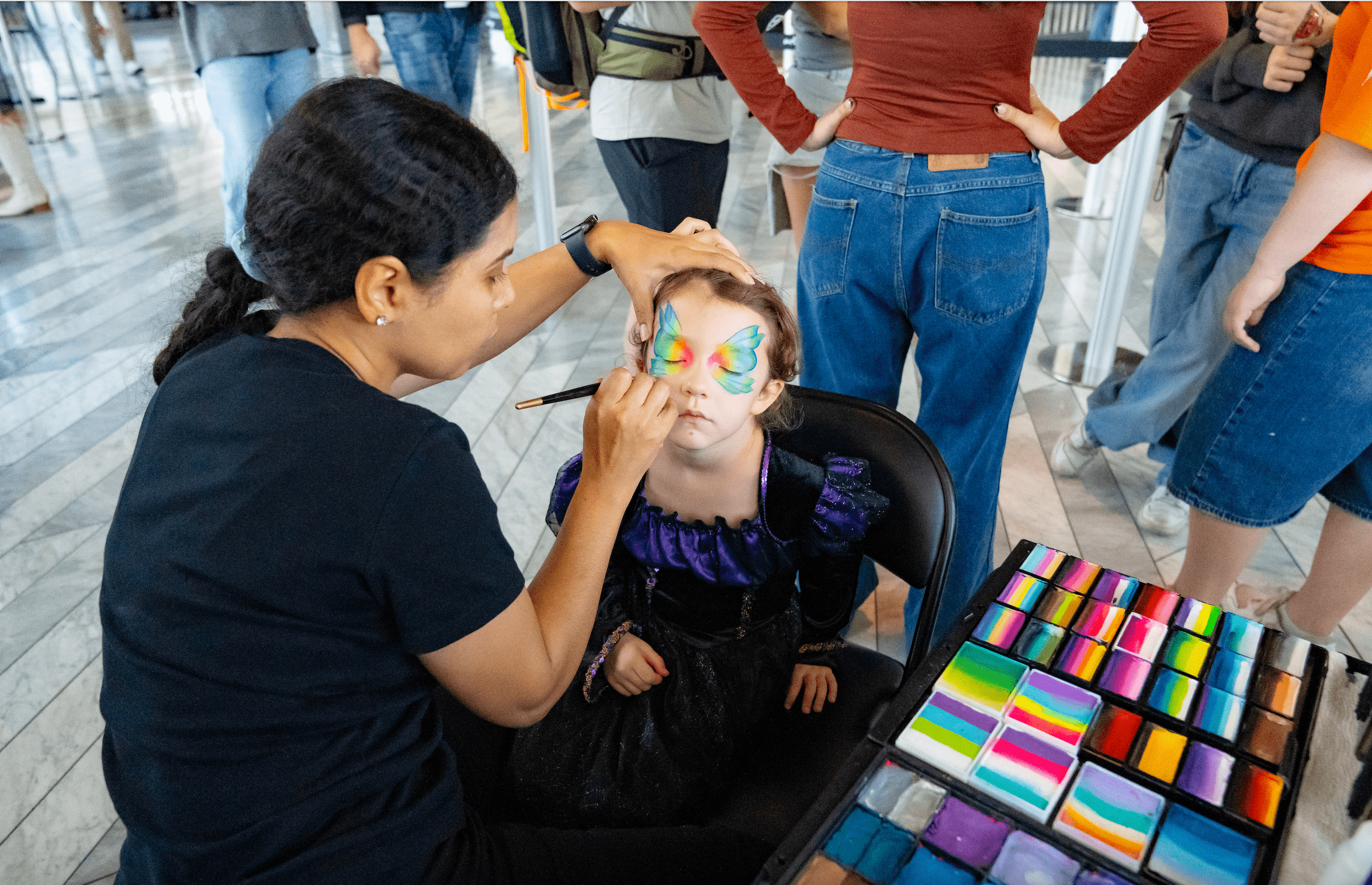 young girl getting her face painted